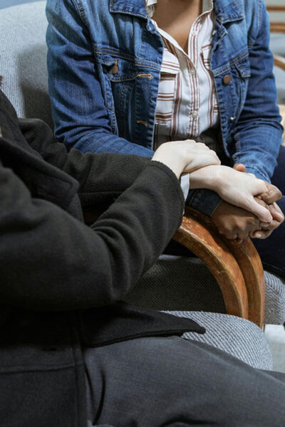 people holding hands in healthcare setting