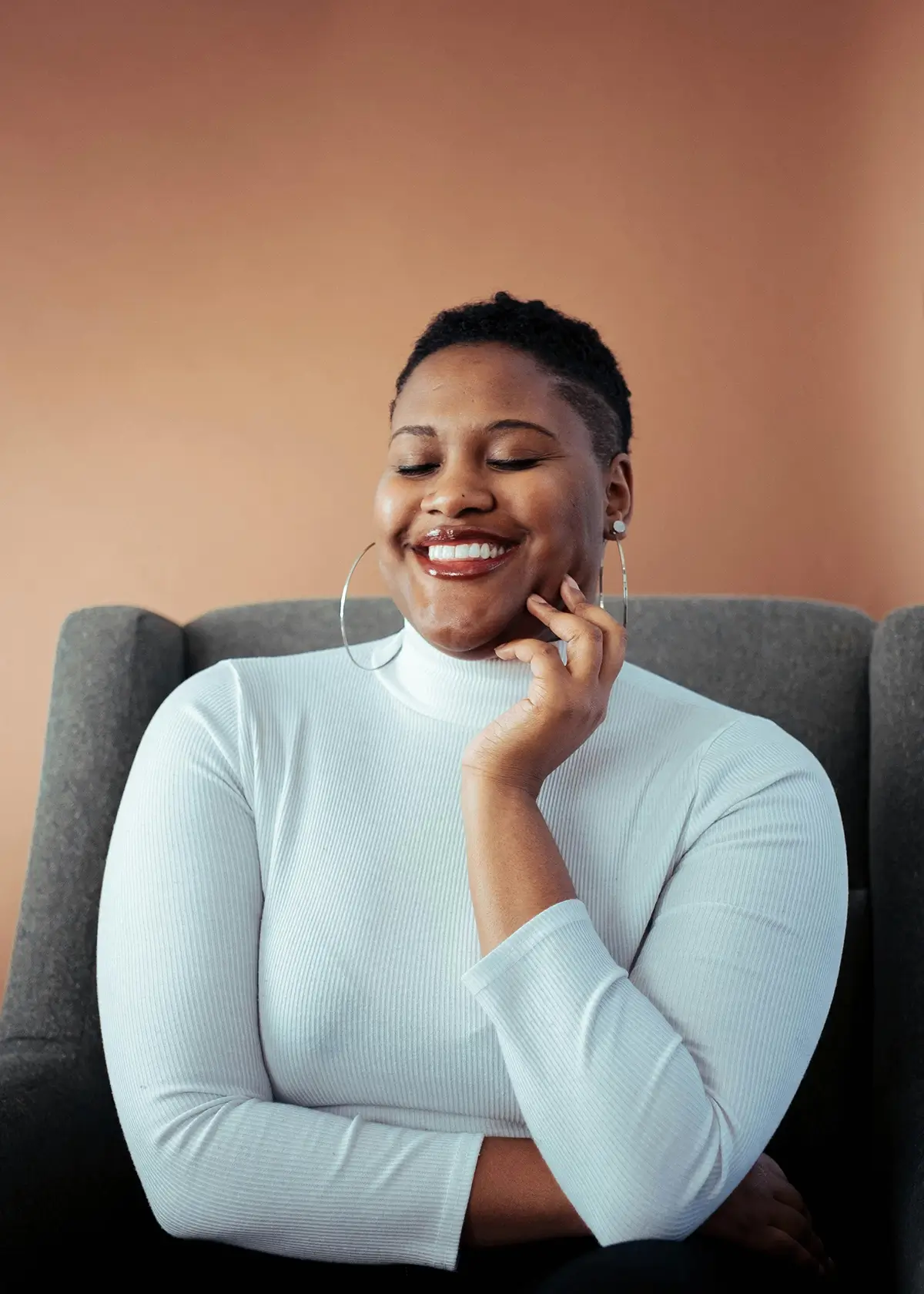 woman in white shirt smiling for article on diet culture and intuitive eating