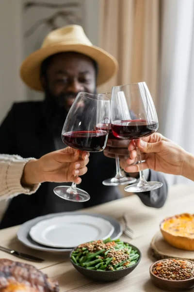 people raising wine glasses to cheers