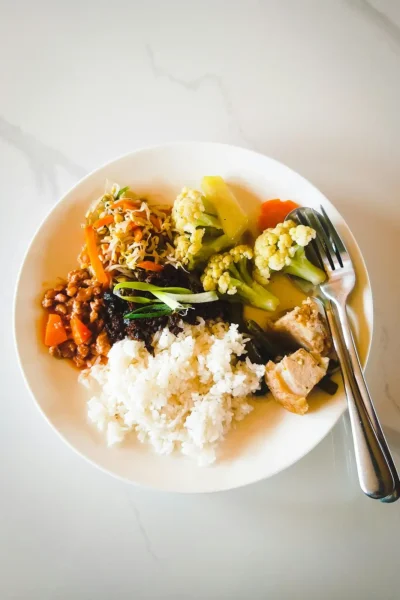 bowl of rice and veggies for article on feeling tired after eating