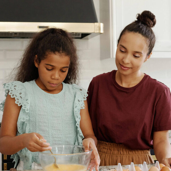 Mom and daughter mixing batter in kitchen