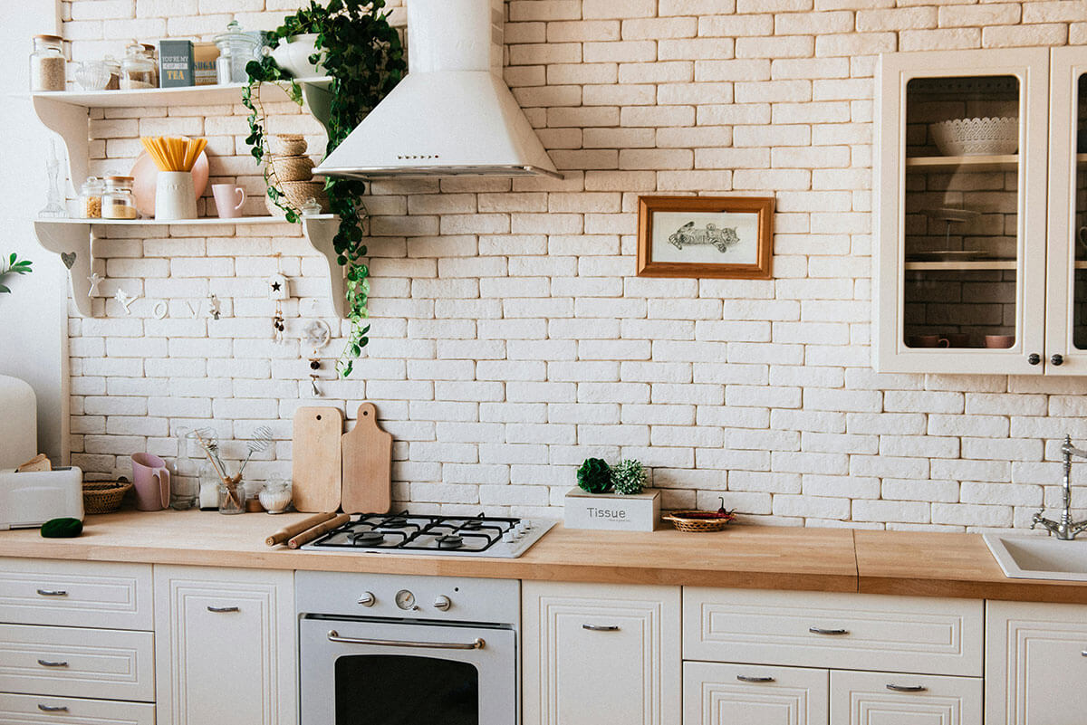charming white kitchen with brick walls used in article for diabetes friendly cooking