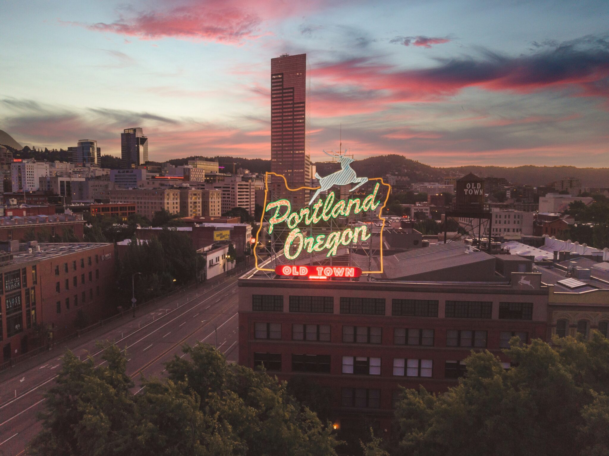 neon portland oregon sign at sunset